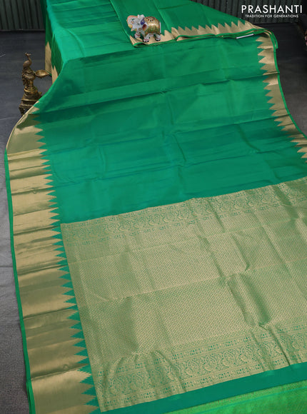Pure kanchipuram silk saree cream with plain body and temple design zari woven border