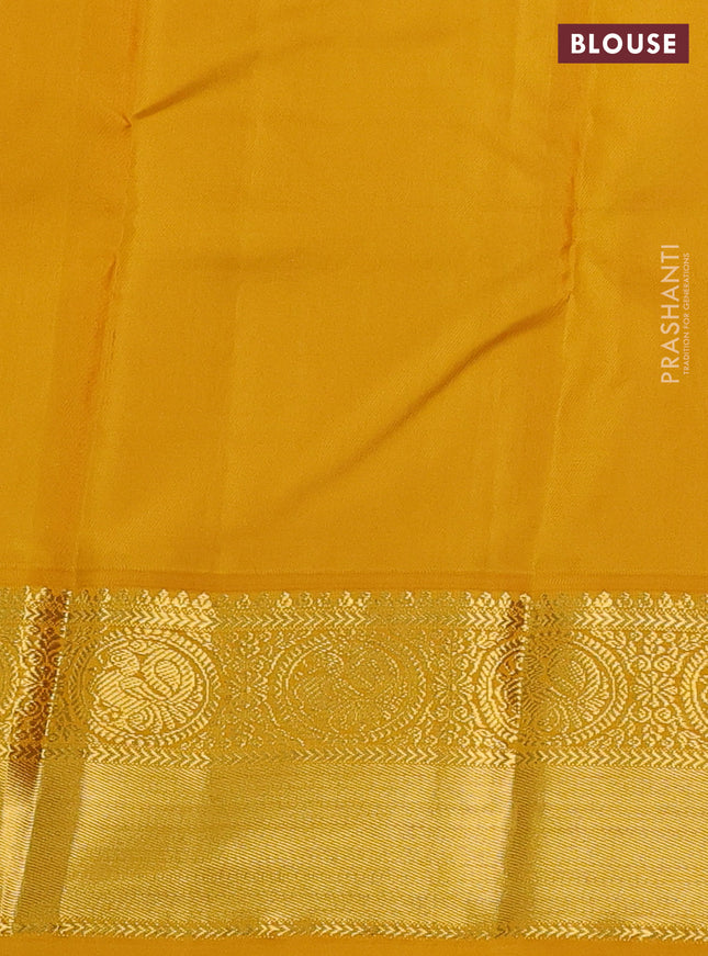 Pure kanchipuram silk saree dual shade of pinkish orange and mustard yellow with zari woven buttas and zari woven korvai border