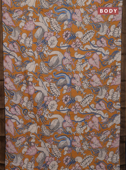 Kalamkari semi silk saree dark mustard and black with allover prints and zari woven border