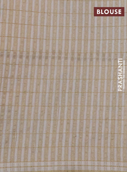 Semi tussar saree cream with allover zari checks & digital prints and zari woven border