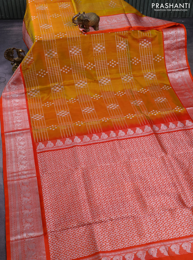 Venkatagiri silk saree dual shade of mustard yellow and orange with allover silver zari weaves and annam silver zari woven border