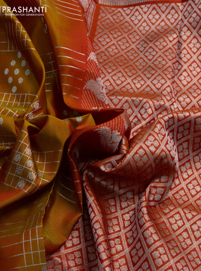 Venkatagiri silk saree dual shade of mustard yellow and orange with allover silver zari weaves and annam silver zari woven border