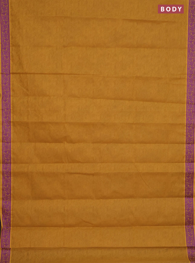 Coimbatore cotton saree dark mustard and purple with allover self emboss and thread woven border