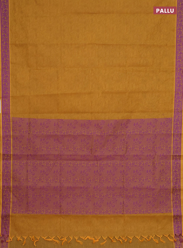 Coimbatore cotton saree dark mustard and purple with allover self emboss and thread woven border