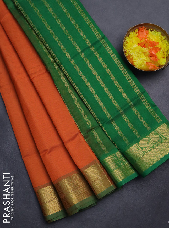Silk cotton saree orange and green with plain body and zari woven border