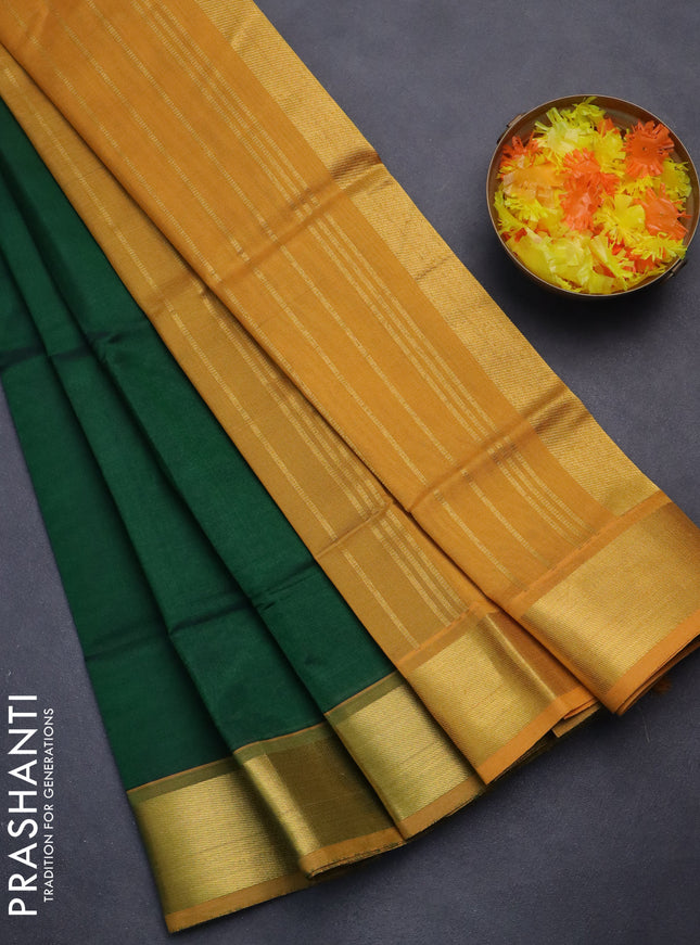 Silk cotton saree green and mustard yellow with plain body and zari woven border