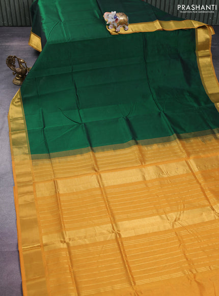 Silk cotton saree green and mustard yellow with plain body and zari woven border