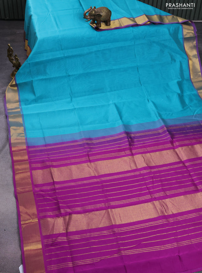 Silk cotton saree teal blue and purple with plain body and zari woven border