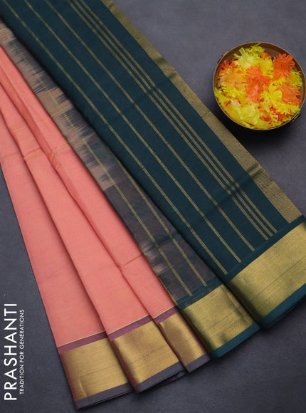Silk cotton saree peach pink and bottle green with plain body and zari woven border