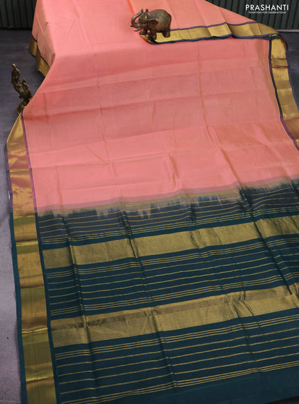 Silk cotton saree peach pink and bottle green with plain body and zari woven border