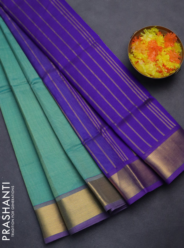 Silk cotton saree teal green and blue with plain body and zari woven border
