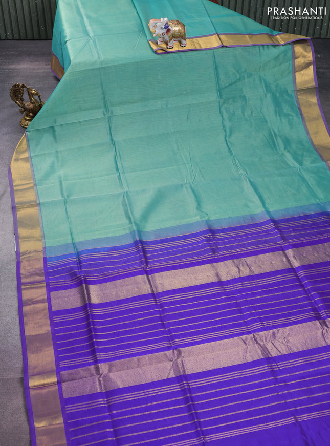 Silk cotton saree teal green and blue with plain body and zari woven border
