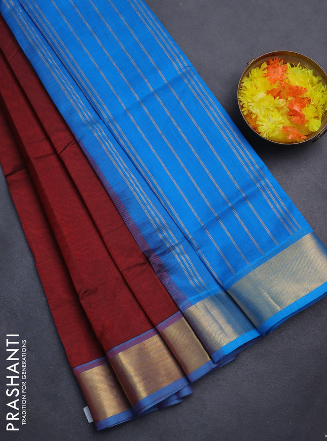 Silk cotton saree maroon and cs blue with plain body and zari woven border