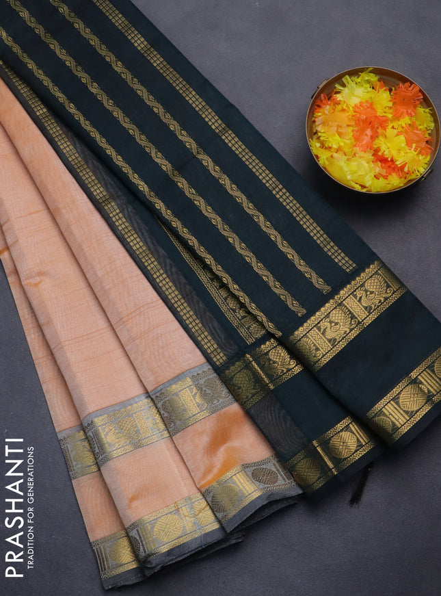 Silk cotton saree pale orange and black with plain body and rettapet zari woven border