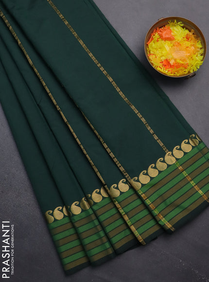 Arani semi silk saree bottle green and mustard yellow with plain body and paisley zari woven simple border