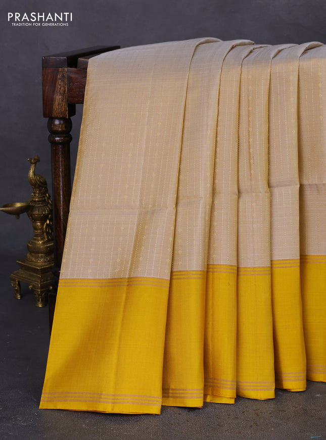 Pure soft silk saree beige and yellow with allover zari weaves and rettapet zari woven border
