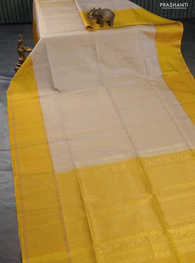 Pure soft silk saree beige and yellow with allover zari weaves and rettapet zari woven border