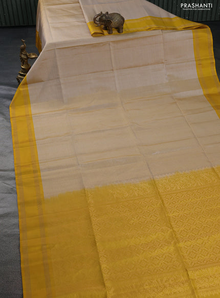 Pure soft silk saree beige and yellow with allover zari checked pattern and rettapet zari woven border