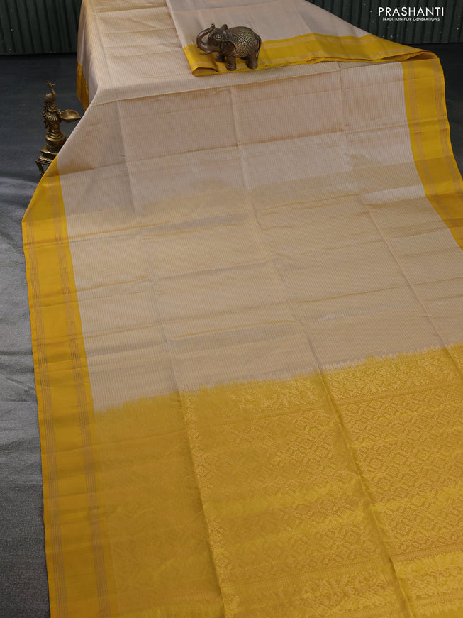 Pure soft silk saree beige and yellow with allover zari checked pattern and rettapet zari woven border