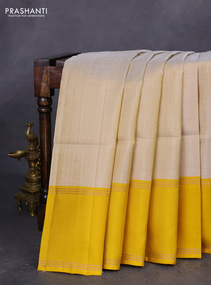 Pure soft silk saree beige and yellow with allover zari weaves and rettapet zari woven border