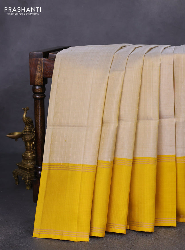 Pure soft silk saree beige and yellow with allover zari weaves and rettapet zari woven border