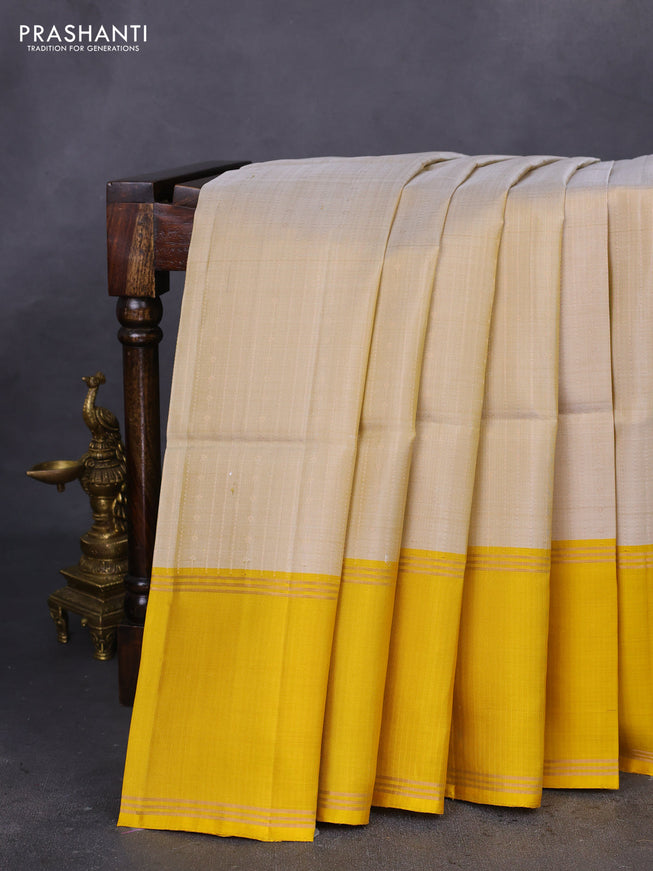 Pure soft silk saree beige and yellow with allover zari weaves and rettapet zari woven border