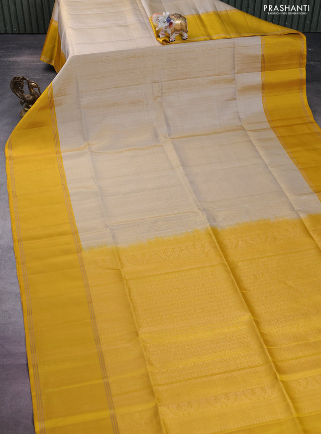 Pure soft silk saree beige and yellow with allover zari weaves and rettapet zari woven border