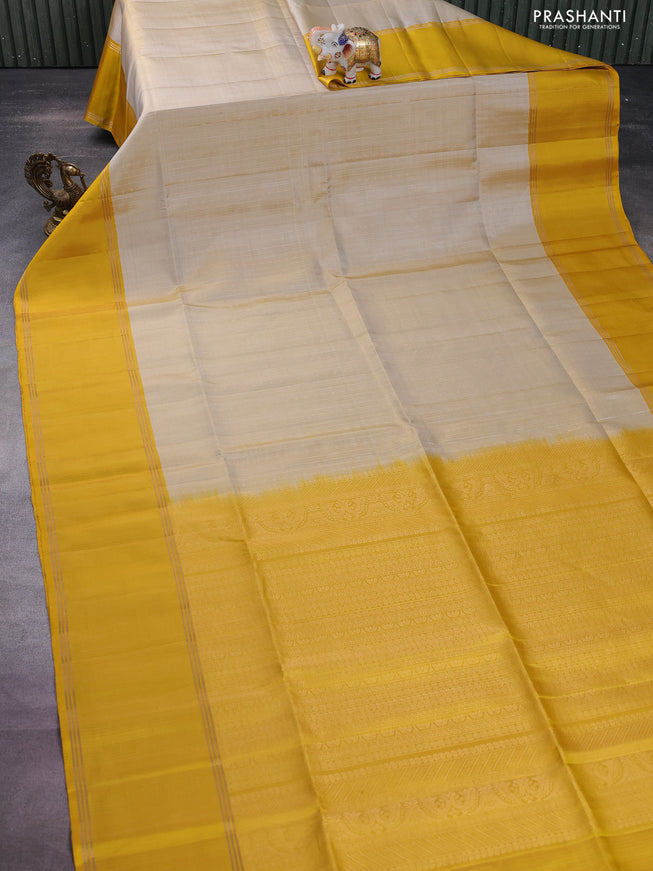 Pure soft silk saree beige and yellow with allover zari weaves and rettapet zari woven border