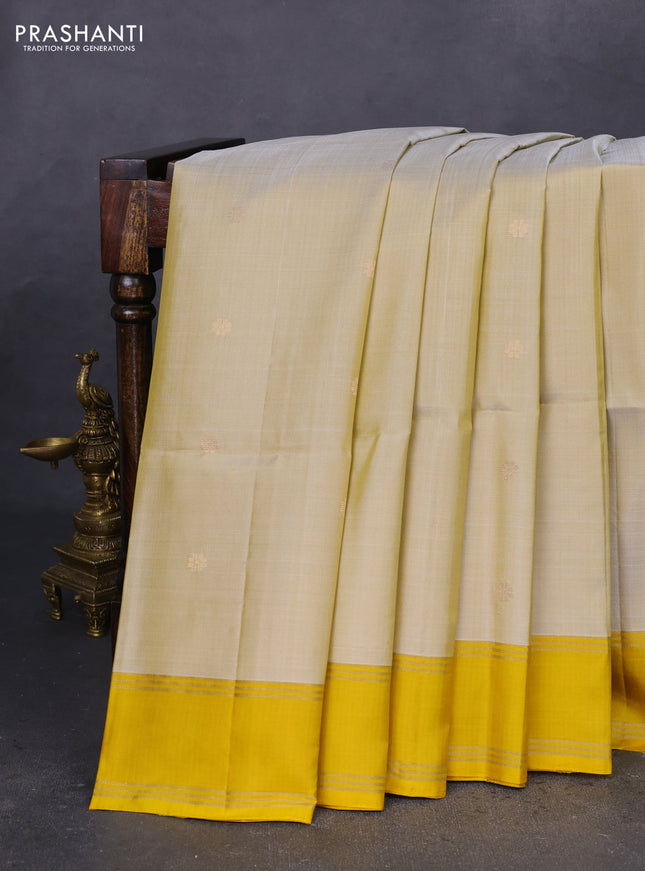 Pure soft silk saree cream and yellow with zari woven floral buttas and rettapet zari woven border