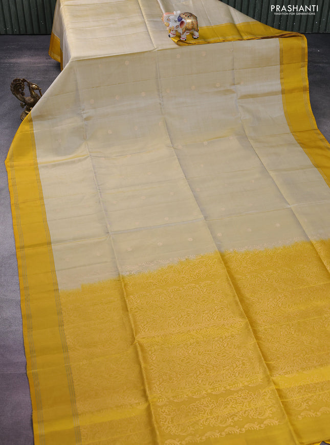 Pure soft silk saree cream and yellow with zari woven floral buttas and rettapet zari woven border