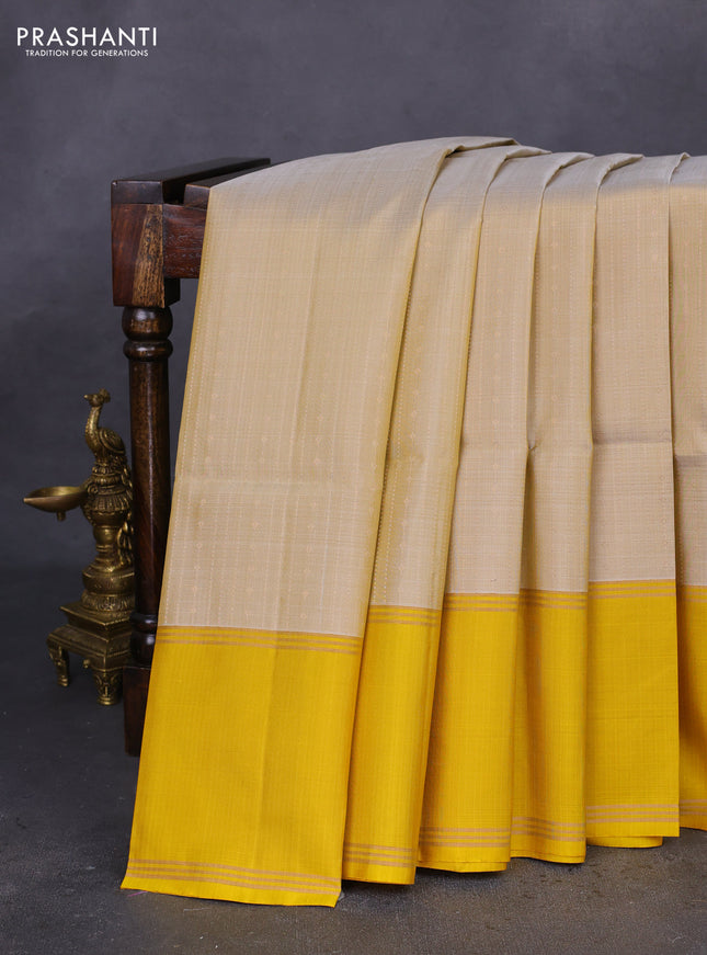 Pure soft silk saree beige and yellow with allover zari weaves and rettapet zari woven border