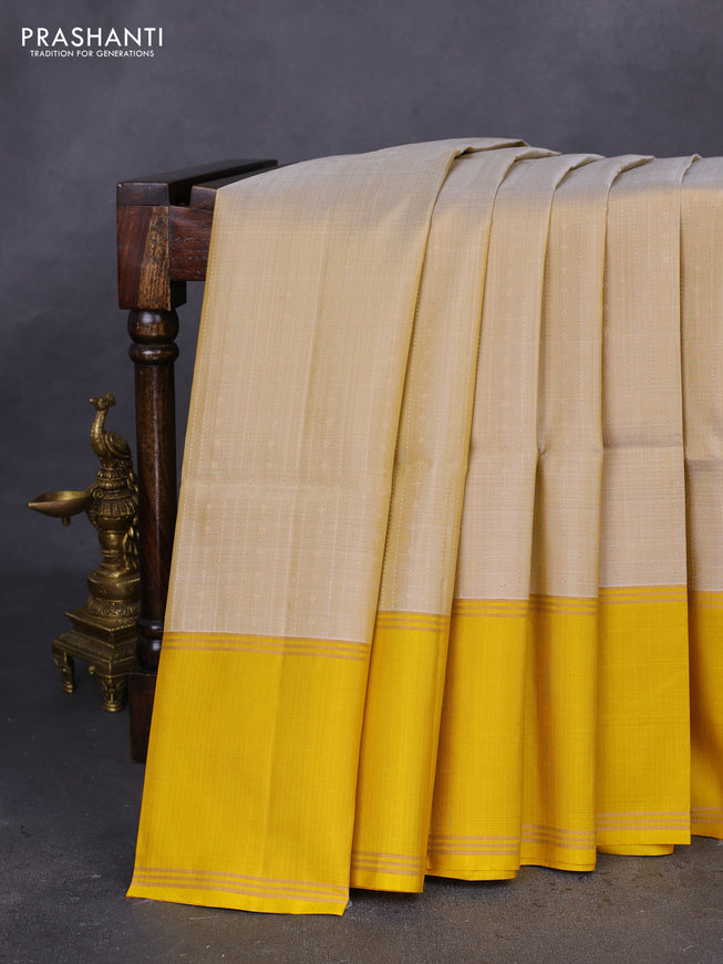 Pure soft silk saree beige and yellow with allover zari weaves and rettapet zari woven border