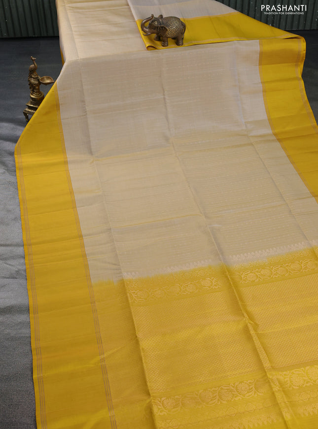 Pure soft silk saree beige and yellow with allover zari weaves and rettapet zari woven border