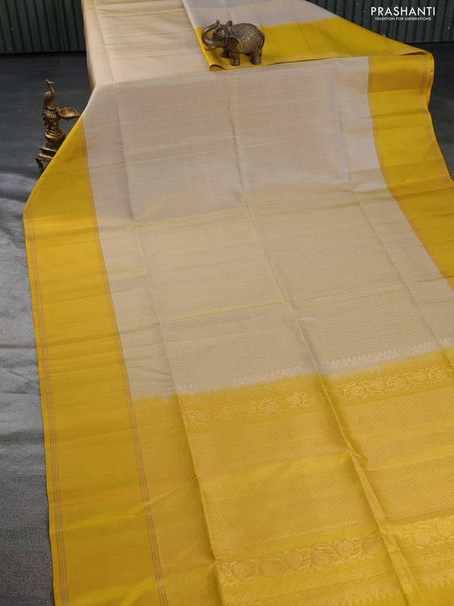 Pure soft silk saree beige and yellow with allover zari weaves and rettapet zari woven border