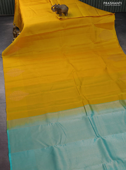 Kanchipuram silk saree yellow and teal blue with allover self emboss and self emboss zari butta border