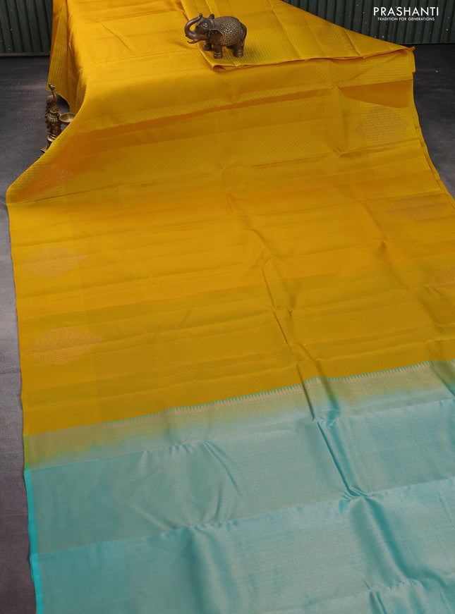 Kanchipuram silk saree yellow and teal blue with allover self emboss and self emboss zari butta border