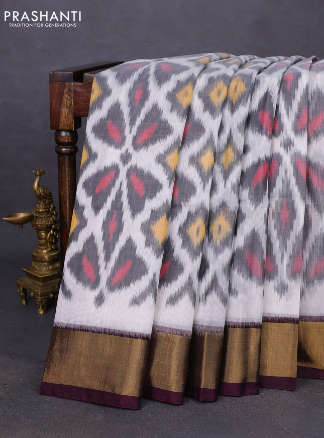 Ikat silk cotton saree off white and deep coffee brown with allover ikat weaves and zari woven border