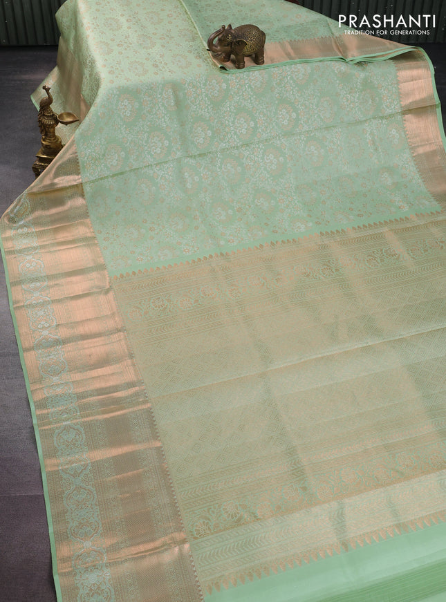 Pure kanchipuram silk saree pastel green shade with allover silver & gold zari woven brocade weaves and rich copper zari woven border