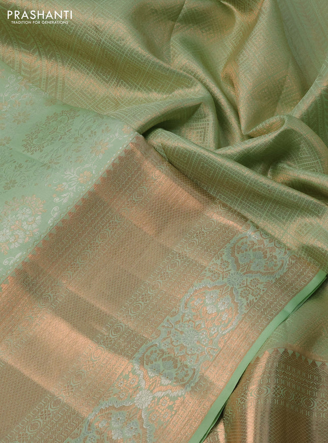 Pure kanchipuram silk saree pastel green shade with allover silver & gold zari woven brocade weaves and rich copper zari woven border