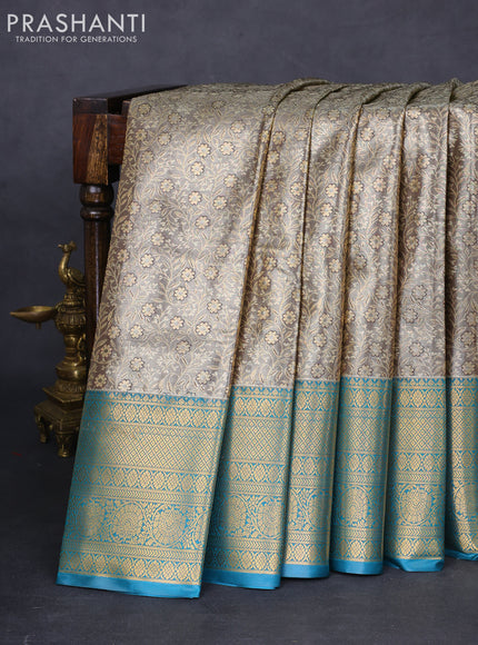 Bangalori tissue silk saree grey shade and peacock blue with allover zari woven brocade weaves and long zari woven border