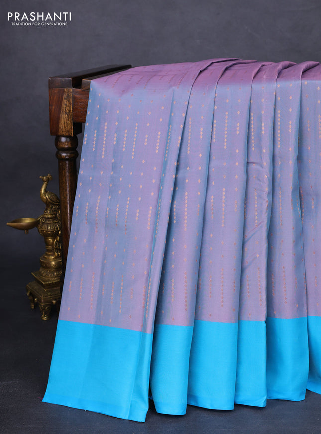 Kanchipuram silk saree dual shade of greyish pink and teal blue with allover copper zari woven butta weaves and simple border