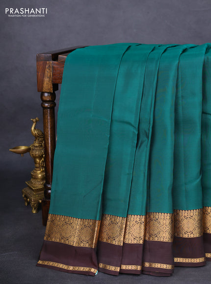 Kanchipuram silk saree green and brown with plain body and rettapet zari woven border