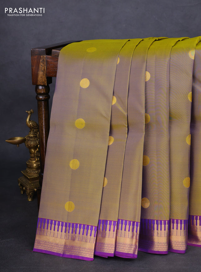 Kanchipuram silk saree dual shade of green and violet with zari woven geometric buttas and temple design zari woven border