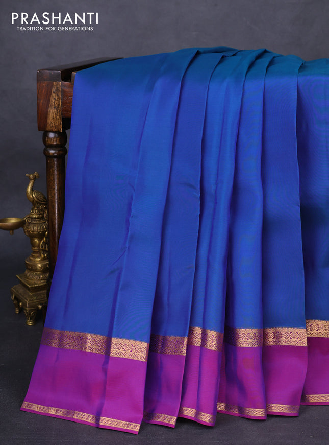 Kanchipuram silk saree dual shade of bluish green and purple with plain body and rettapet zari woven border