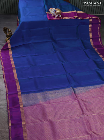 Kanchipuram silk saree dual shade of bluish green and purple with plain body and rettapet zari woven border