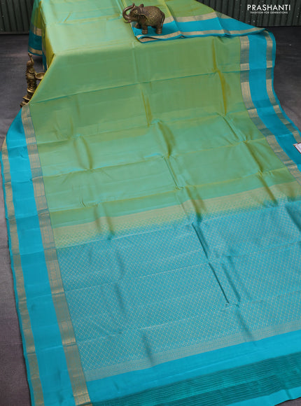Kanchipuram silk saree dual shade of teal green and teal blue with plain body and rettapet zari woven border