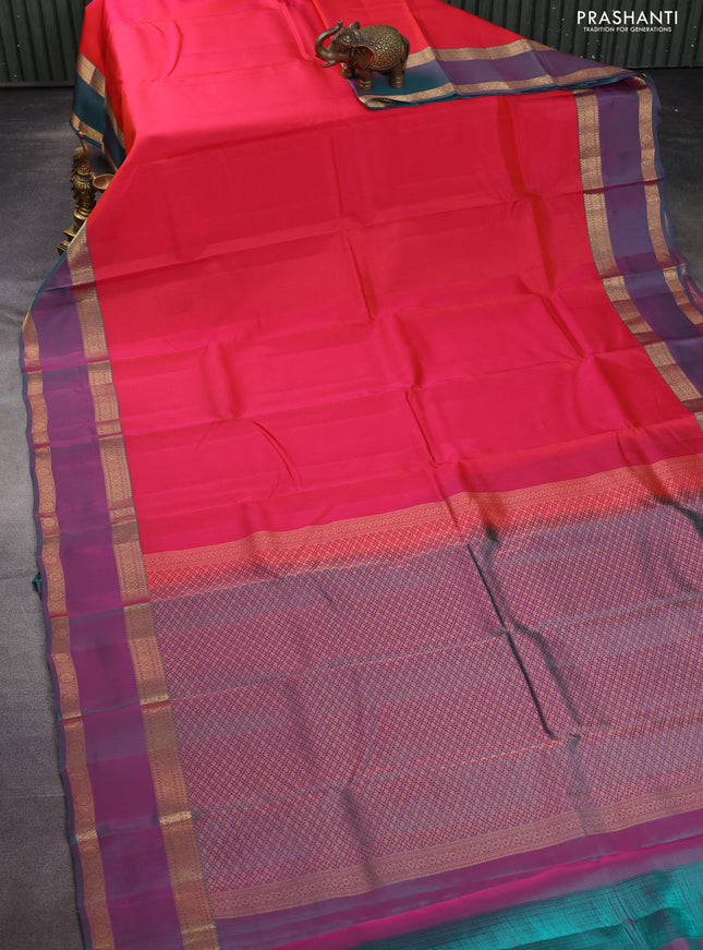 Kanchipuram silk saree dual shade of pinkish orange and dual shade of teal green with plain body and rettapet zari woven border