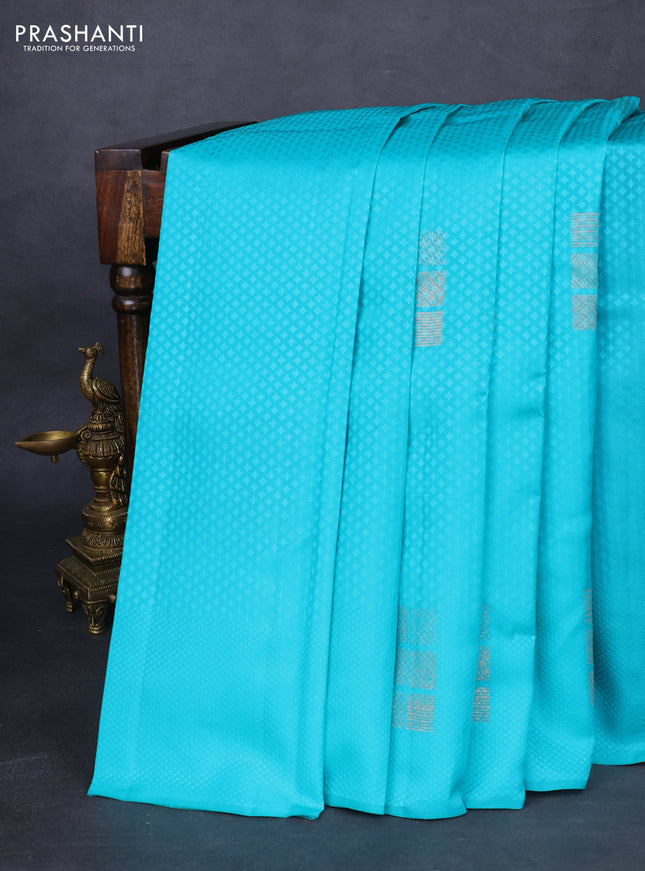 Kanchipuram silk saree teal blue and red with allover self emboss and zari butta border