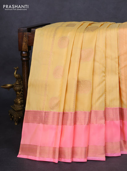 Kanchipuram silk saree pale yellow and peach pink with allover copper zari weaves and rettapet copper zari woven border