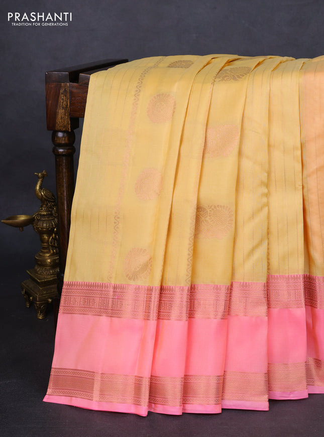 Kanchipuram silk saree pale yellow and peach pink with allover copper zari weaves and rettapet copper zari woven border
